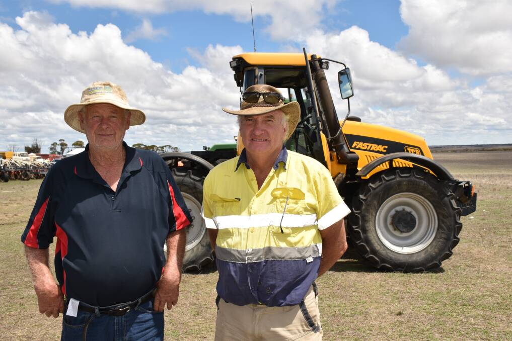 Brian Auld (left), Jerdacuttup and Lance Norwood, Gibson, in front of the JCB 3185 Fastrac (5000 hours) that achieved the sale's top price of $46,000, paid by local West River farmer Michael Dougherty.