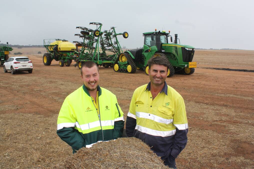Tractor driver Olly Martin (left), and Beverley/York farmer Duncan Young, ready to start the season seeding lupins last week, using a new John Deere 9RX articulated four-track tractor which Duncan bought from Ag Implements, Northam. It's the first model on three metre spacings to be delivered on-farm in WA.