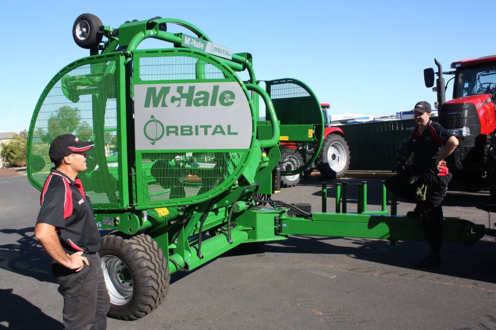 Western Ag Bunbury branch manager Gavin Young (left) and mechanic Tom Foster prepare this automatic McHale Orbital wrapper for delivery to a local farmer. It is the first of its kind in WA and already has drawn inquiries from local farmers.
