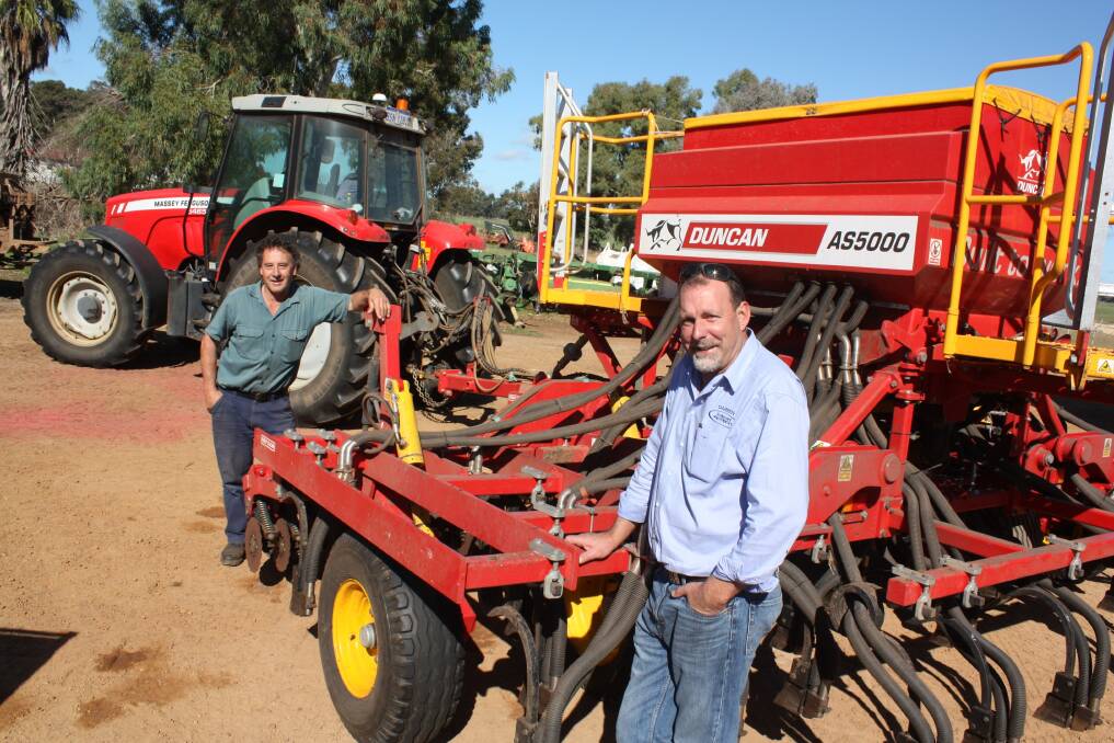 Tutunup farmer Graham Armstrong (left) and Bunbury Machinery branch manager Darren Pulford discuss completing the Armstrong's 890 hectare program sowing ryegrass with this Duncan Renovator AS5300 air seeder.
