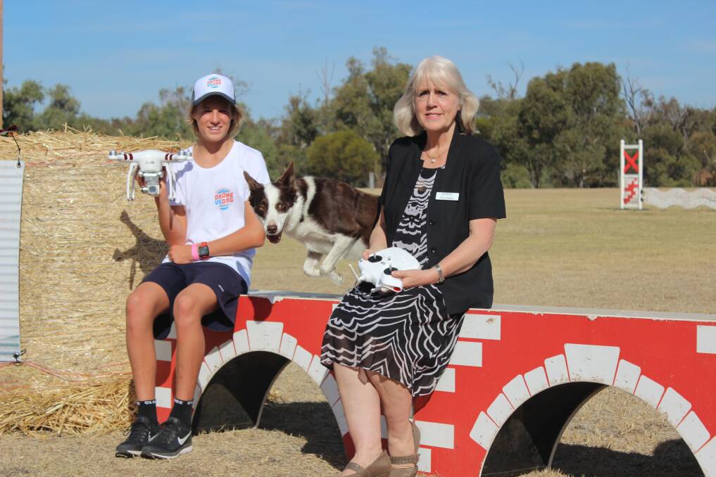  Winner of the Drone versus Dog competition Archie Le Grice, a John Curtin College of the Arts year 11 student with the prize he won for the college, and Muresk Institute general manager Prue Jenkins. Leaping between them is Jay the border collie/kelpie cross who beat Archie's time but was disqualified for missing the final obstacle.