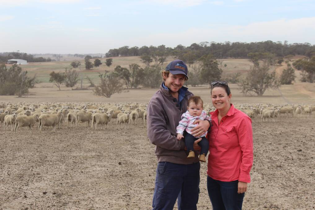  Arthur River producers Paul and Janelle South pictured with their daughter Maddy, and pregnant ewes in the dust before last week's rain.