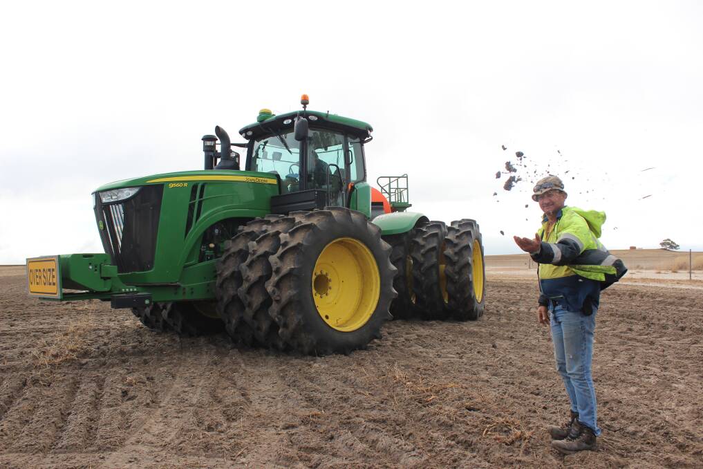 The soil is almost damp enough to clump when farm worker Jan De Plessis squeezes it and throws it in the air as the tractor and air-seeder come past sowing barley on Friday morning halfway between Calingiri and Wongan Hills.