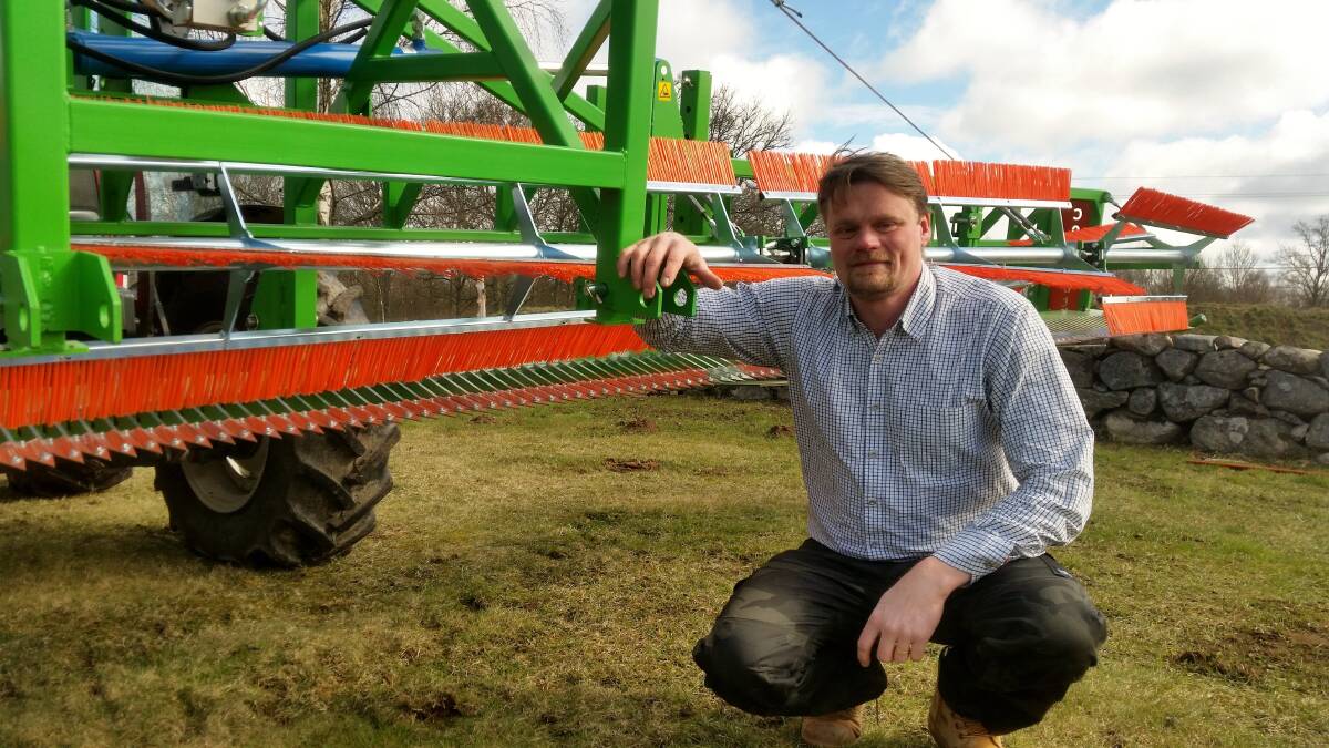 Inventor Jonas Carlsson with his CombCut machine that is designed to control weeds in organic farming systems.