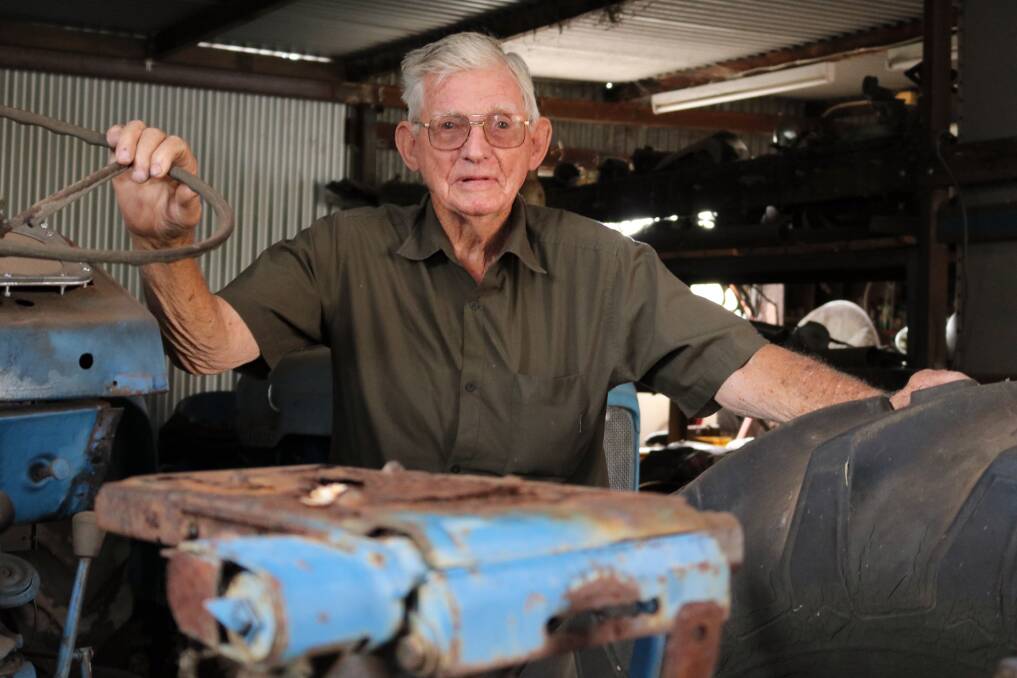 Roger May in his natural habitat – deep in the back shed working on old tractors.