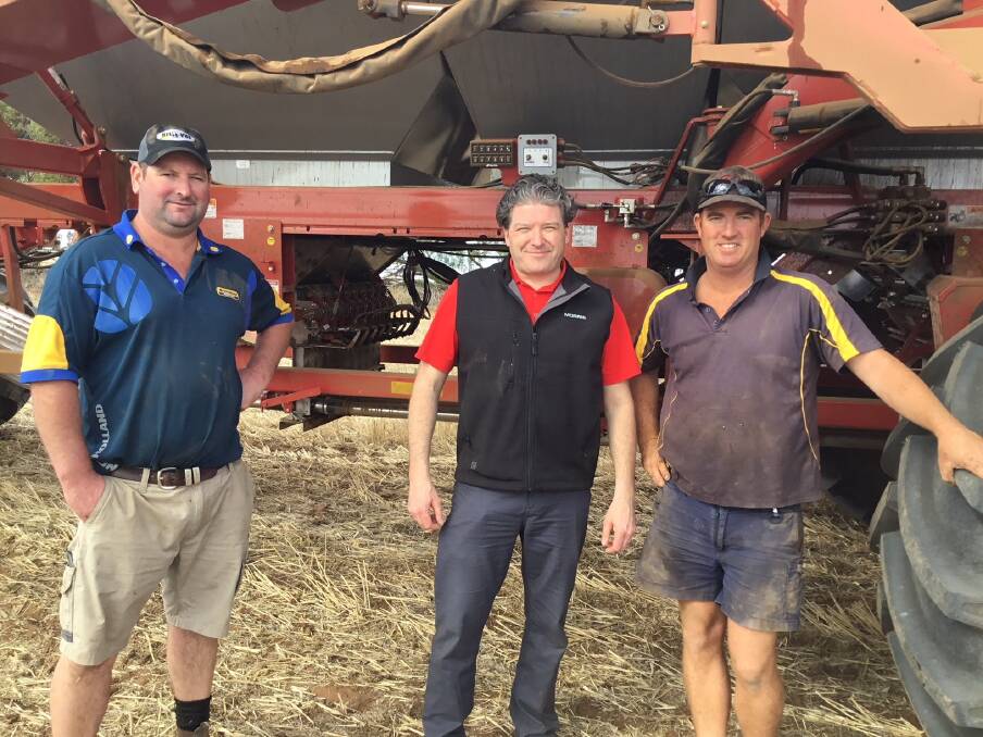  Justin Ward (left), Belle-Vue Trading, Warracknabeal, Victoria and Morris Industries president and chief executive officer Ben Voss look over a Morris 9550 air cart with input control technology (ICT) with Victorian grower Nathan Williams, Beulah, during the Morris group's recent tour across the country.