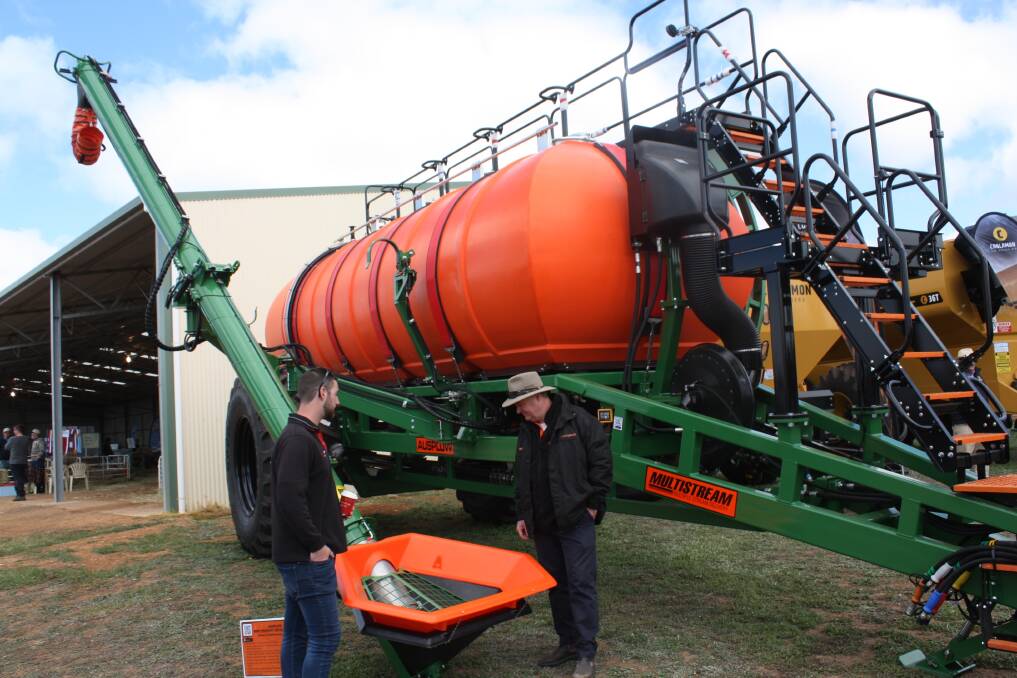 Farmer's Centre Esperance salesman Jakke Little (left) and Ausplow general manager Chris Farmer discuss the features of the new auger on the company's Series II Multistream air seeder with liquid capability.