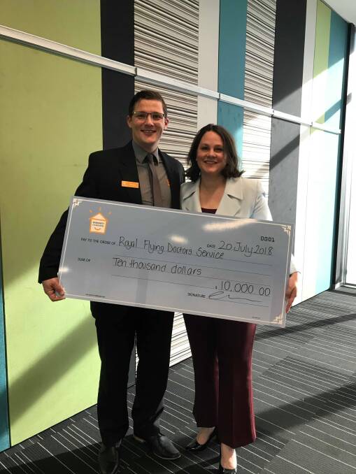  Wagin branch manager Brenden Hall, the 2018 Bankwest Volunteer of the Year, presents his prize to Rebecca Tompkinson from the Royal Flying Doctor Service.