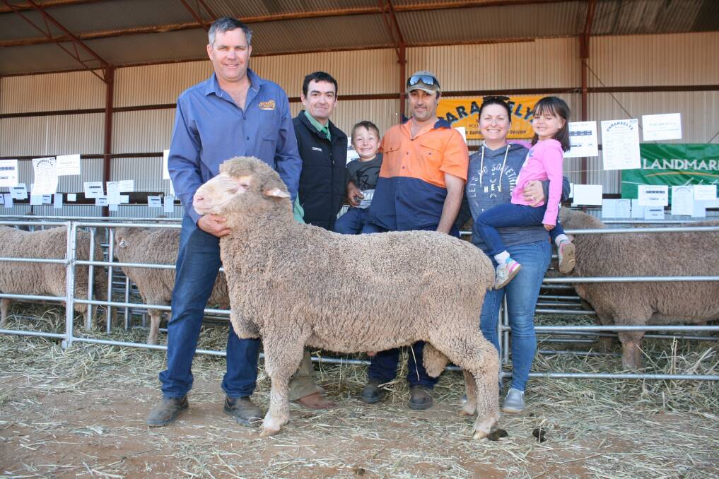 The Madaffari family paid $2800 for this top-priced ram at the 39th annual Parakeelya Poll Merino stud ram sale. Pictured were Parakeeyla stud principal Andrew Dunne (left), Landmark's Danny Nixon, buyer Paul Madaffari holding his son Myles, six, and his wife Estelle holding daughter Alena, four.