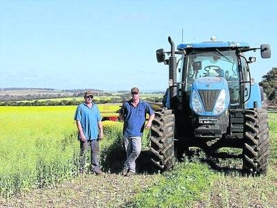 Brad Jennings (left) and Murray Paterson, Pingelly Hay Service, have helped growers to make the most of average canola crops by cutting, raking, and baling it for hay.