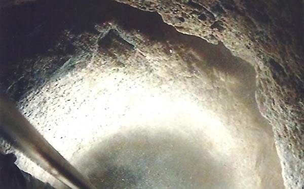 Fault line: This photograph was taken by a remote-controlled camera inside the Merredin drill hole. As they drilled through solid granite at a depth of 327 metres, Globe Drill came across this fault line (seen here as a dark crack), from which water was flowing in vast quantities.