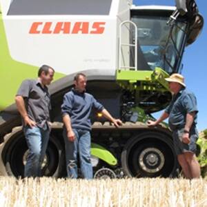 Wellard Rural Services sales and service northern Wheatbelt representative Dermot Joyce (left) discusses the new tracked system on the CLAAS Lexion 700 combine harvester with Wellard Rural Services operations manager Terry Reilly and Ajana farmer John Ralph. The system is the world's first factory engineered-and-fitted tracked system for combine harvesters.