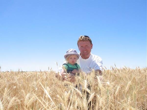 Pindar farmer Mark Flannagan with his daughter Sahara in a crop of Arrino wheat which will produce an average yield between 1.4t/ha and 1.6t/ha. Mark is convinced the trial work on his property will lead to more understanding of how to grow higher-yielding crops in low rainfall areas.