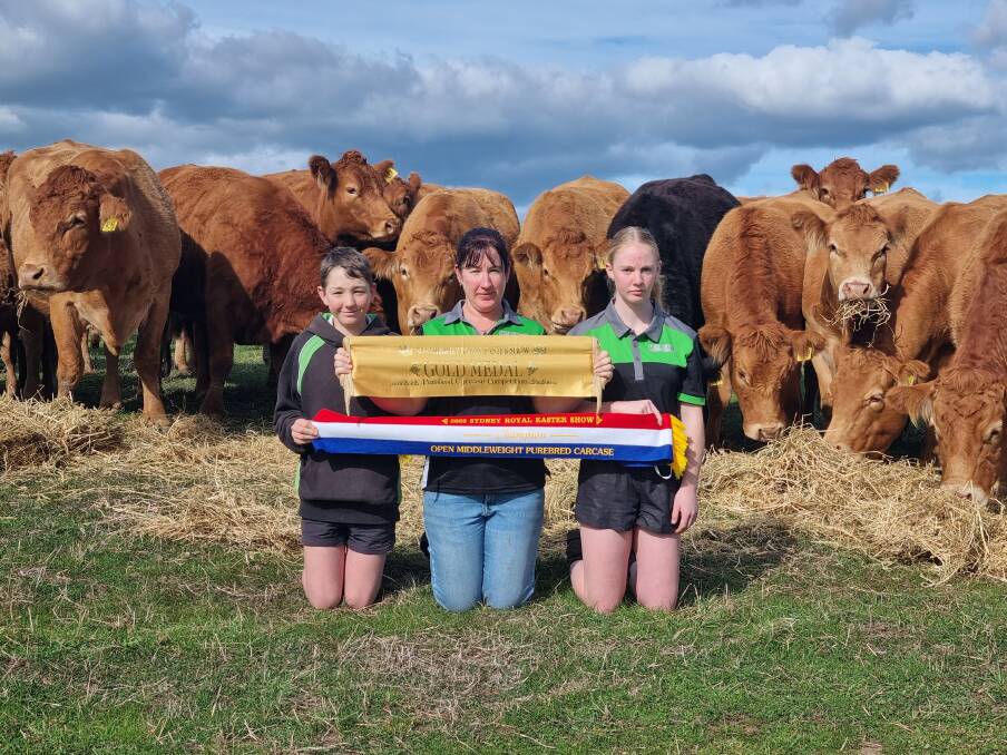 Morrisvale co-principal Casey Morris (centre), Narrikup, with son Spencer and daughter Libby show off the gold medal ribbon and champion open middleweght purebred carcase ribbon, won by one of their purebred Limousin steers at last months Sydney Royal Easter Show.