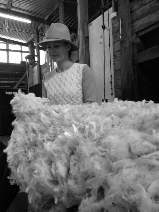 Ali Wood looking over the fleece at her familys sheep farm.