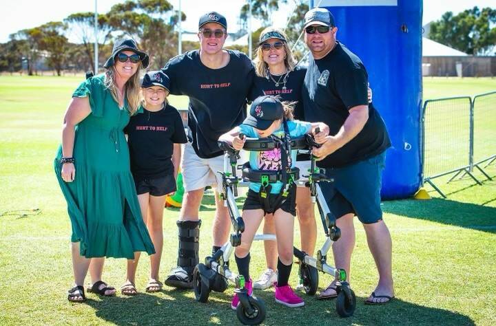 Ethan Stirrat (centre) with the Gilpin family, the first recipients of Hurt to Helps fundraising. It comes after Hollie Gilpin (front) was diagnosed with Batten disease. 
