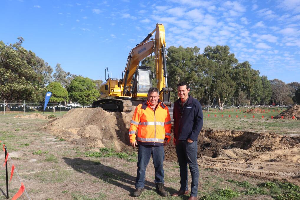 Matt Chapman (left), All Excavator Hire, Landsdale, and Andrew Cox, McIntosh & Son, chat while Mr Chapmans father tries the 922E excavator behind them.