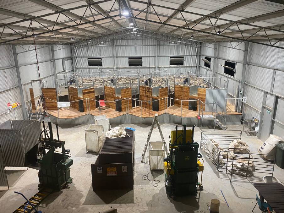 The Proway Livestock Equipment fit-out of the Walters new shearing shed with raised saw-tooth shearing board and a modern wool press with scales either side of the wool table. The roof is high enough to allow large farm machinery to be stored in the front of the shed.