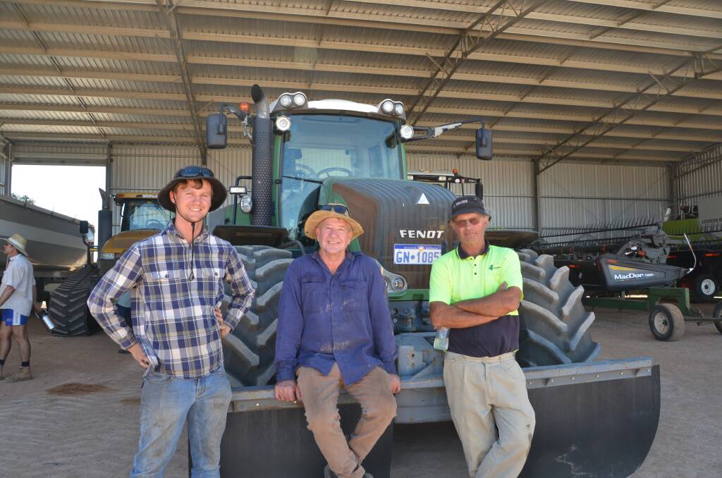 Jordan Flavel (left), Wickepin, his father Conrad and vendor Paul Berger. Jordan lost out in a bidding duel for the Fendt 927 Vario tractor behind them.