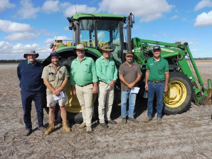 Buyers Malcolm (left) and Mark Leske; agent Barry Hutcheson, clerk Andrew Beaton; vendor Andrew Harris and agent Darren Chatley, with the top sale item, a John Deere 6520 tractor with front end loader that sold for $55,000.