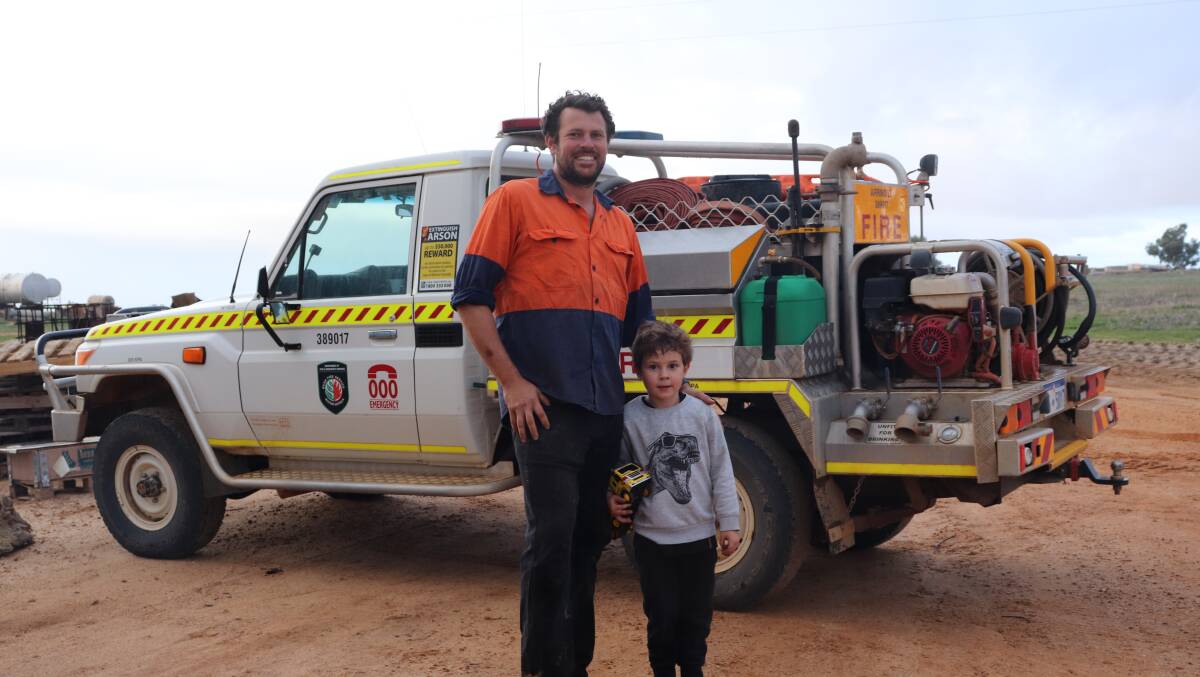 Mr Bone and Liam in front of the volunteer fire vehicle. 