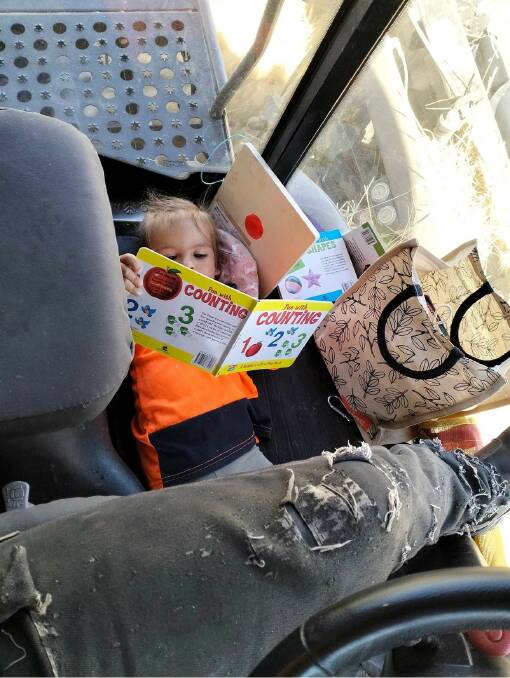 Piper managing some down-time, reading when her dad was behind the wheel.
