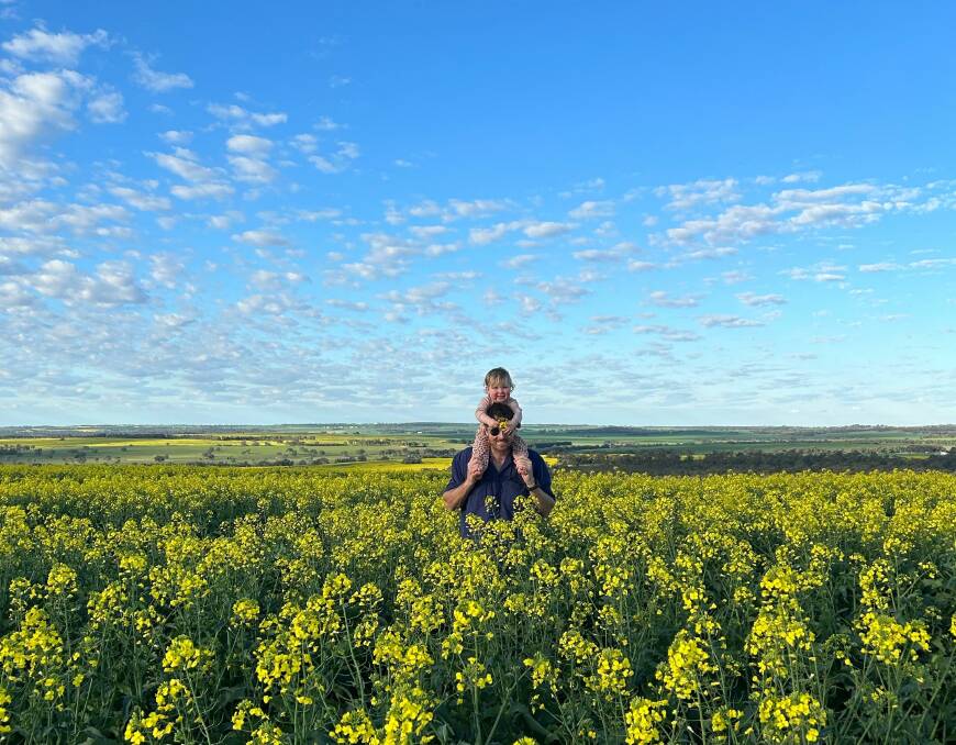 Tim Creagh, Warra Warra, at Dandaragan, inspecting the canola crop with his daughter Frankie.