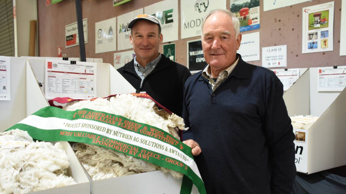Tilba Tilba stud principals Andrew (left) and Stuart Rintoul, Williams, with one of their fleeces which received a champion ribbon for being the most valuable (highest commercial value) fleece in classes 15, 16, 18, 19, 27 and 28 of competition after being valued at $124.79.