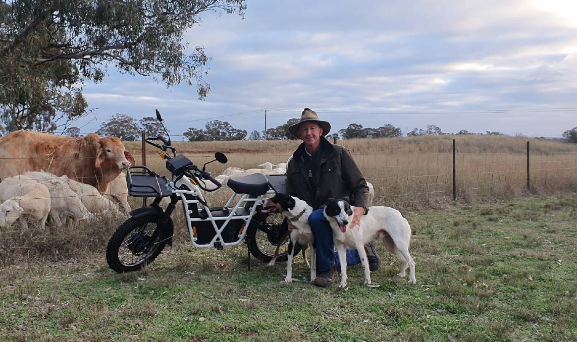 Scott Smith, Dubbo, with Border Collies Flo and Jack and the road registered UBCO bike, Picture supplied