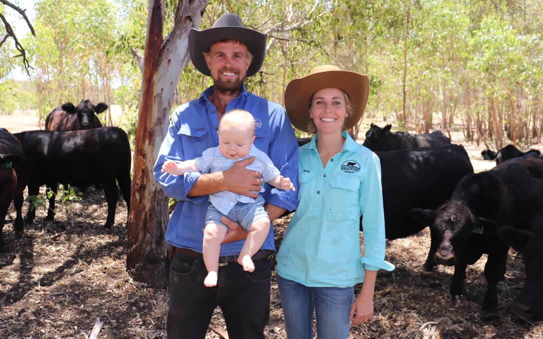 First-generation farmers Patrick O'Dea and Asher Goddard, Bradford Cattle Co, Orange Springs, with their eight-month-old son Tanner and a herd of purebred Simmental females behind them.