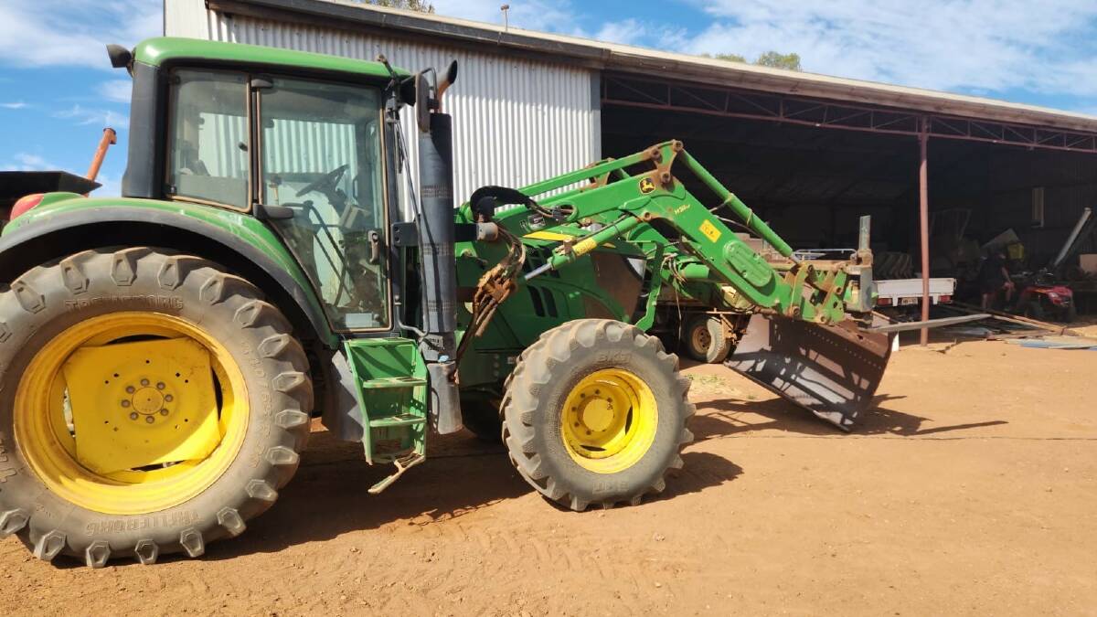  This John Deere 6105M tractor with front end loader, including bucket and forks and airconditioned cab was the top item, selling for $60,000.