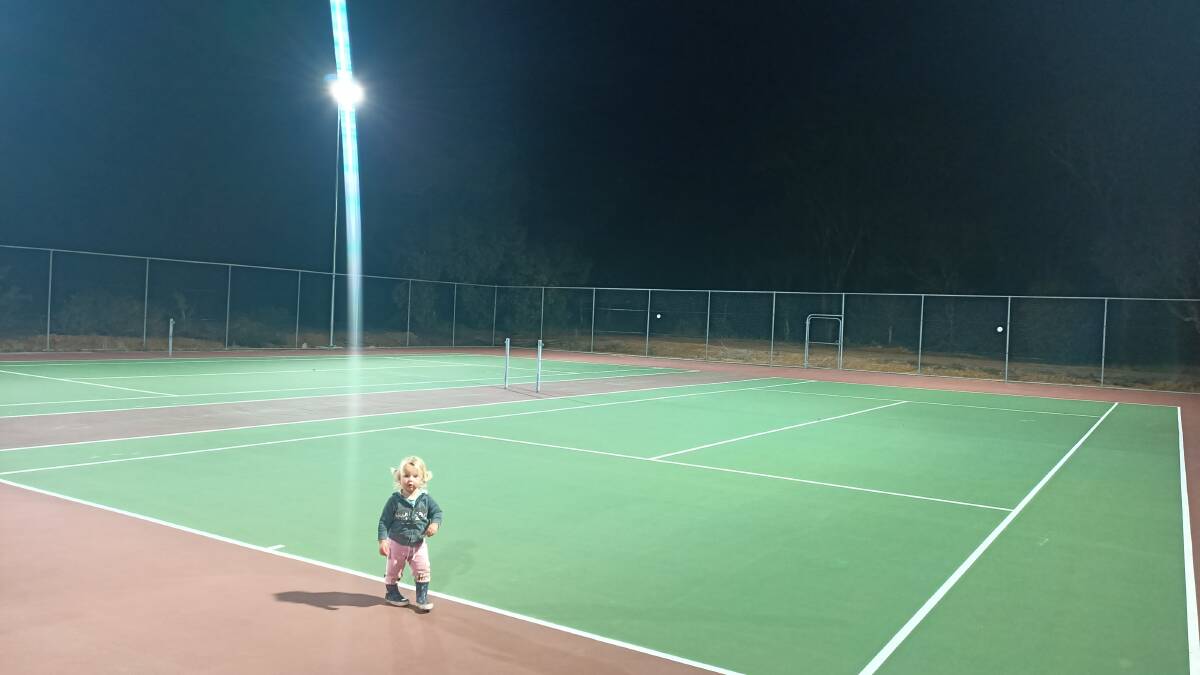 Frankie Slade, 18 months, enjoying the well-lit courts at the Kendenup Tennis Club.