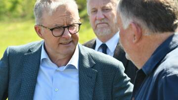 Prime Minister Anthony Albanese speaking with Latrobe farmer Michael Perkins in Tasmania as Latrobe mayor Peter Freshney watches on. Picture by Brodie Weeding.