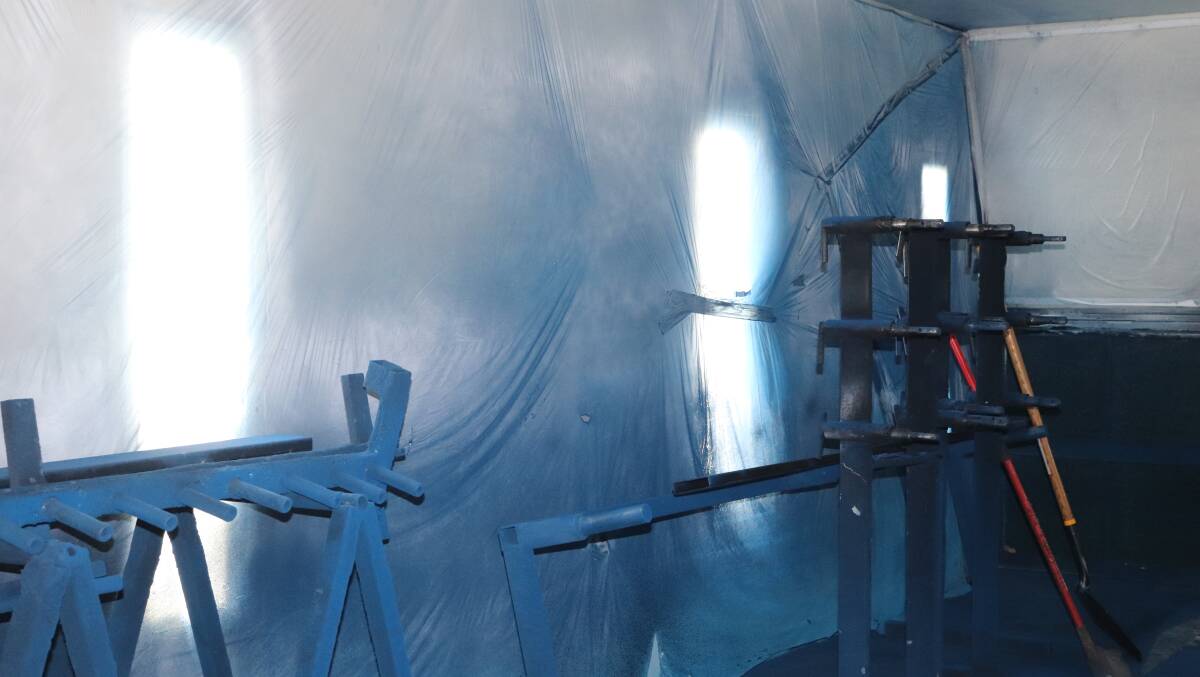 Sieve frames are painted blue in the paint booth.