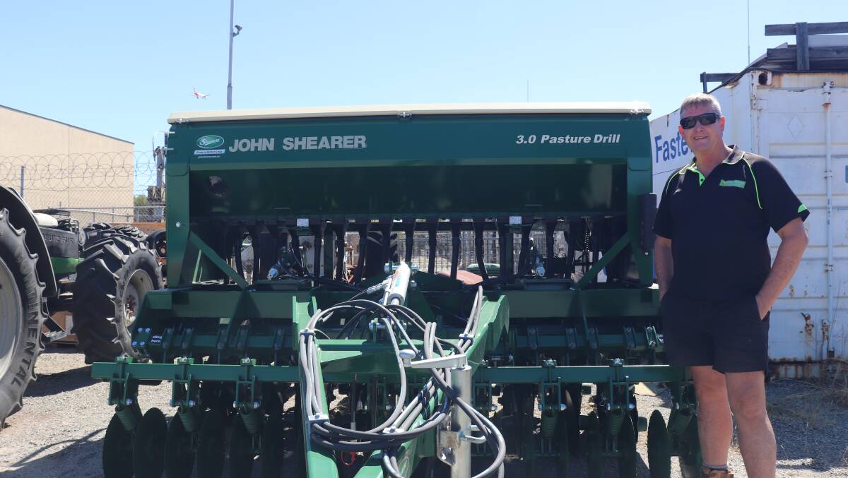 Fred Hopkins owner Gary Johnson with one of the John Shearer Pasture Drills at the dealership in Welshpool.