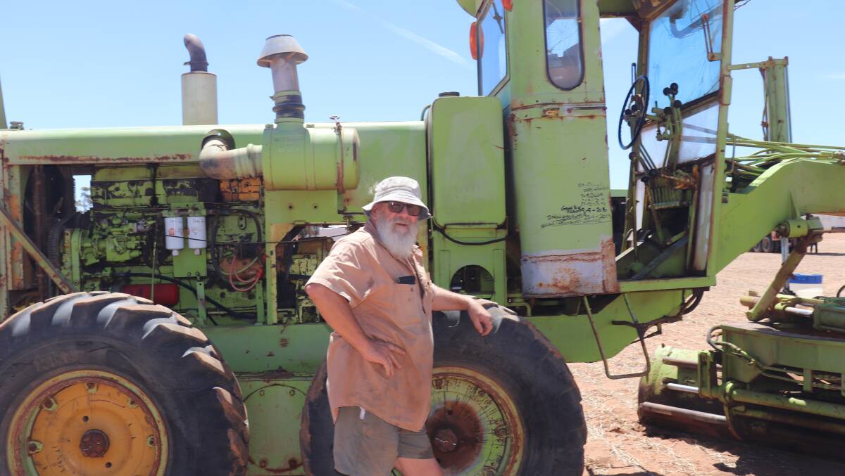 Greg Lyons, Cadoux, relaxing by a 1970 DRMCO Hyd road grader which sold for $37,000.