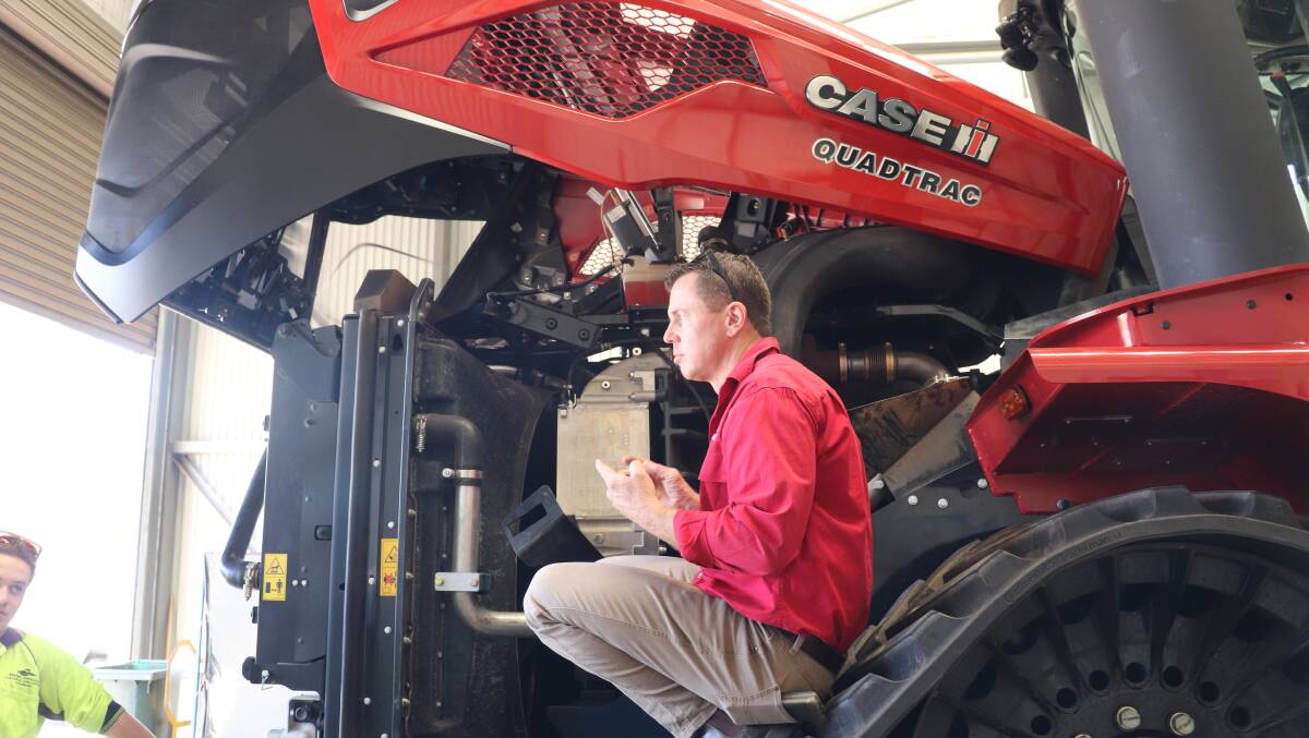CNH product manager Justin Bryant gives WA College of Agriculture - Cunderdin students details on the Steiger 715's engine.