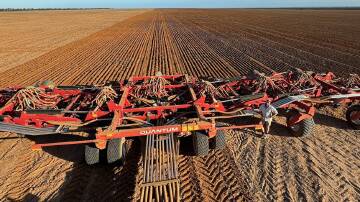 Max Cook is dwarfed by the new 24-metre Morris Quantum air drill that has not skipped a beat despite tough conditions during seeding this season on the family's Salmon Gums property.