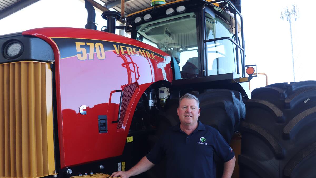 Perth Power Tractors & Machinery salesman David Rogers, Welshpool, by the four-wheel drive 570 Versatile tractor.