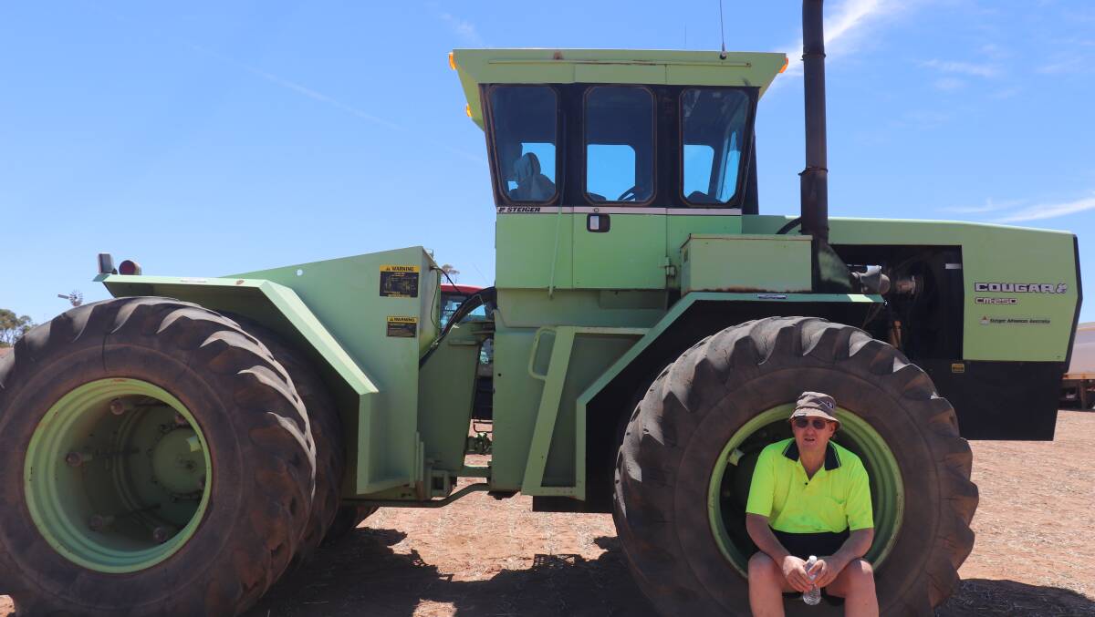 Victor Lee, East Pingelly, taking a break on the front wheel of the 1984 Steiger Courgar tractor, which was snapped up for $24,000.