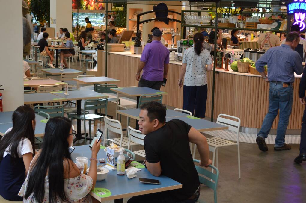 A dining area inside the Honest Bee supermarket.