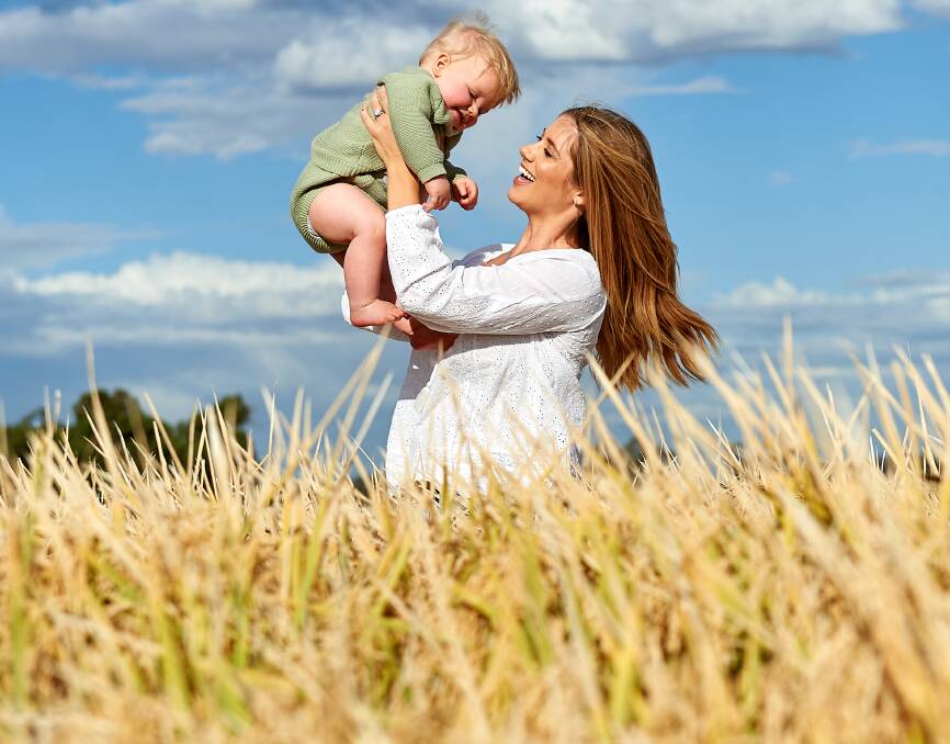 The stars fronting SunRice's new baby rice cereal product promotion, Riverina mum, Erika Burkinshaw and her son is Cove, in a southern NSW rice crop. 