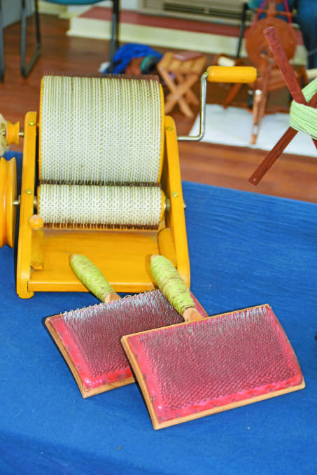 A drum carder and carding brushes are used for brushing raw or washed fibres to prepare them as textiles to be spun into yarn.