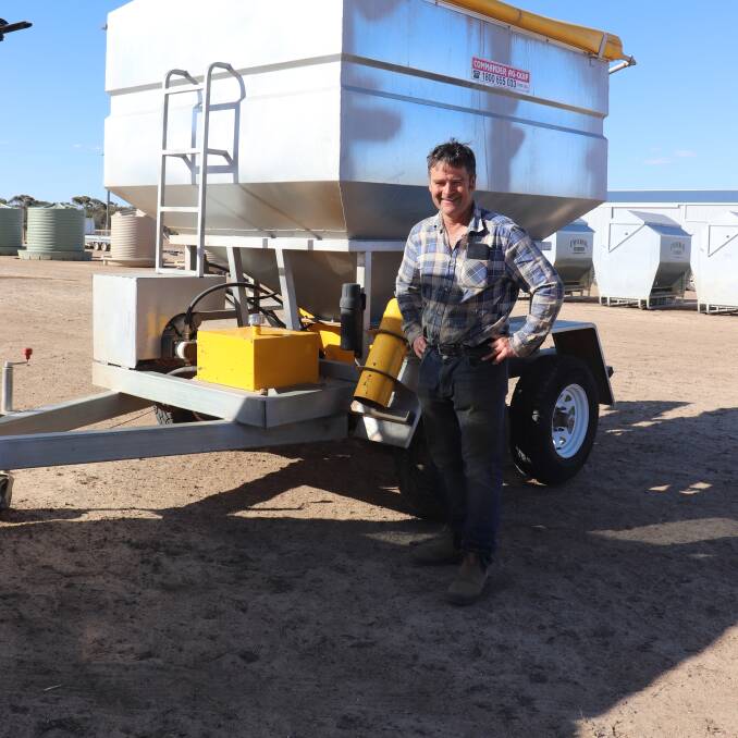 Boxwood Hill farmer Rohan Murdoch with the Commander Ag Quip 4 tonne sheep feed trailer with a 50:50 split electric motor and auger that he brought during the clearing sale for $17,500. Mr Murdoch said he purchased the feeder to feed his sheep and he wanted something reliable.