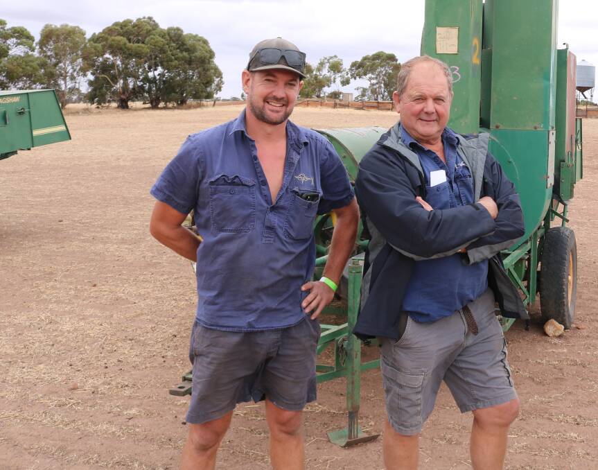 Jason (left) and Robert Melchiorre, Narrogin, with one of the seven clover harvesters that were up for grabs.