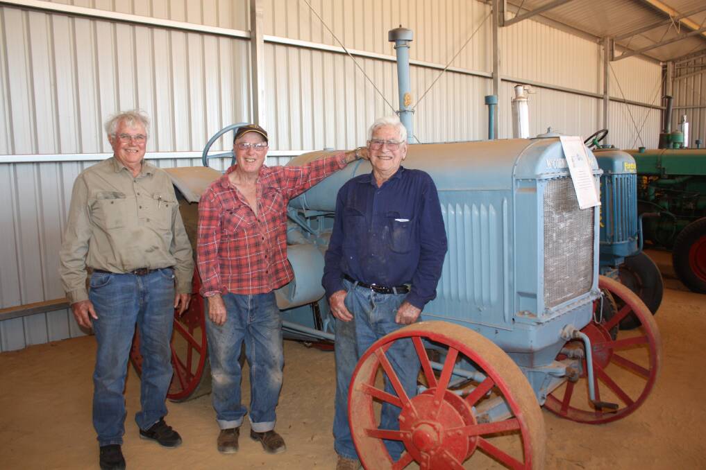 Local Beacon farmers and Men's Shed members John Dunne (left), Peter Sweetman and curator Bruce Ingleton in front of a 1923 McCormick Deering, the oldest tractor in the Men's Shed collection.