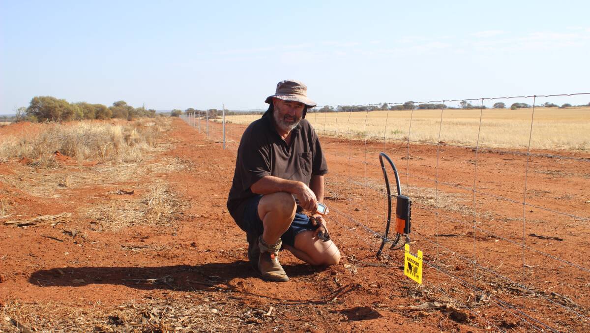 Perenjori sheep producer Chris Patmore with his electric fence that he installed around 15km of his most vulnerable paddocks to prevent wild dog attacks on his flock.