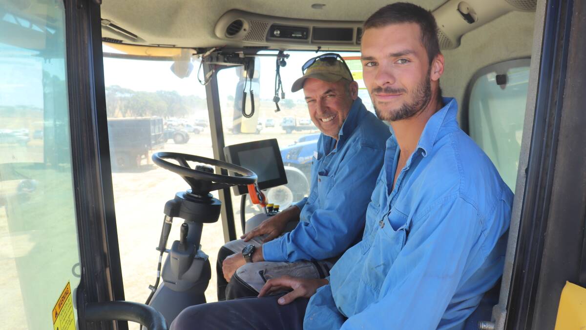 Andrew Bulleid (left) and son Charlie, both from Williams, checking out the combine harvester, but they were really after the big tractor parked next to it. A winning bid of $255,000 got them the tractor.