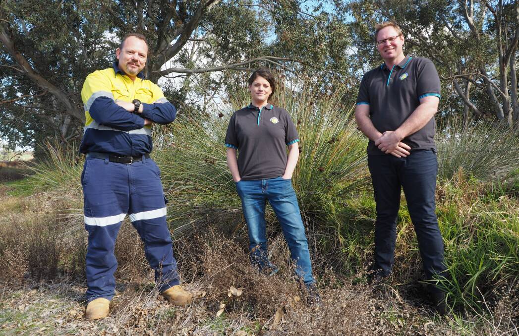Cataby Operations environment specialist Scott Talbot (left), West Midlands Group Natural Resource Management officer Brinley Porter and WMG executive officer Nathan Craig in front of spiny rush at Dandaragan.