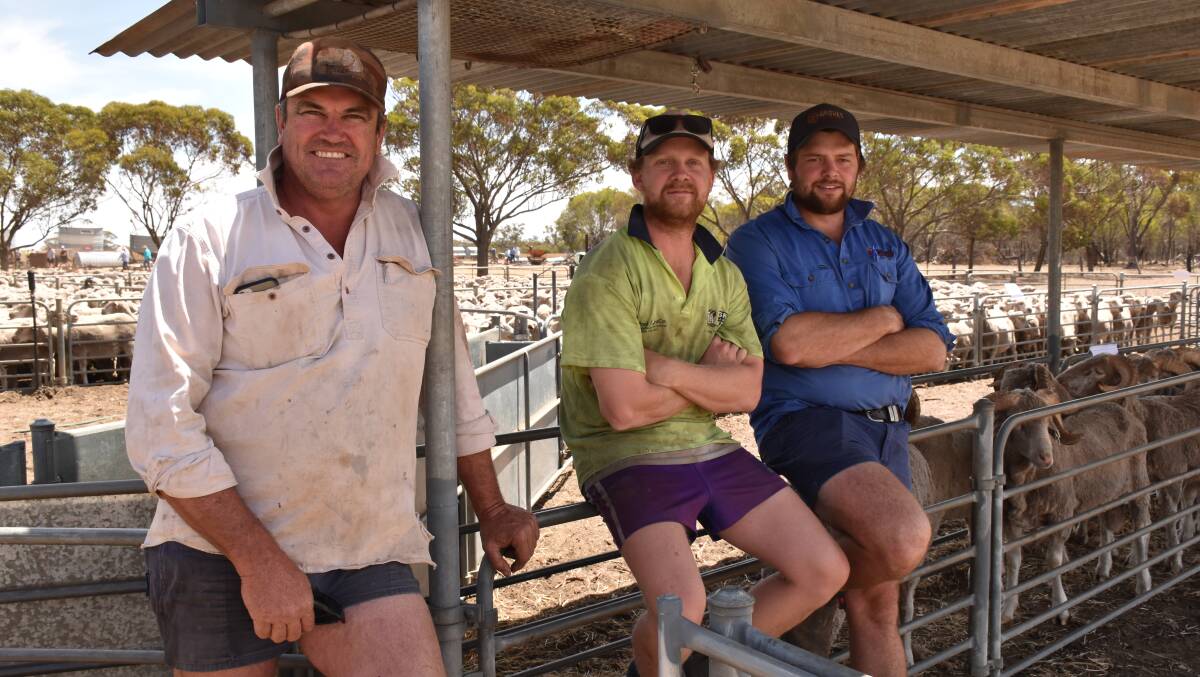 Checking sheep prices at the Lance's clearing sale were near neighbour Collyn Garnett (left), Tim Lance and Reece Groves, Gnowangerup.